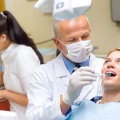 Claremore dentist performs a dental cleaning for a patient.