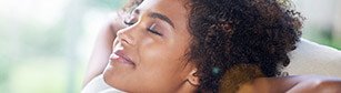 woman with closed eyes smiling